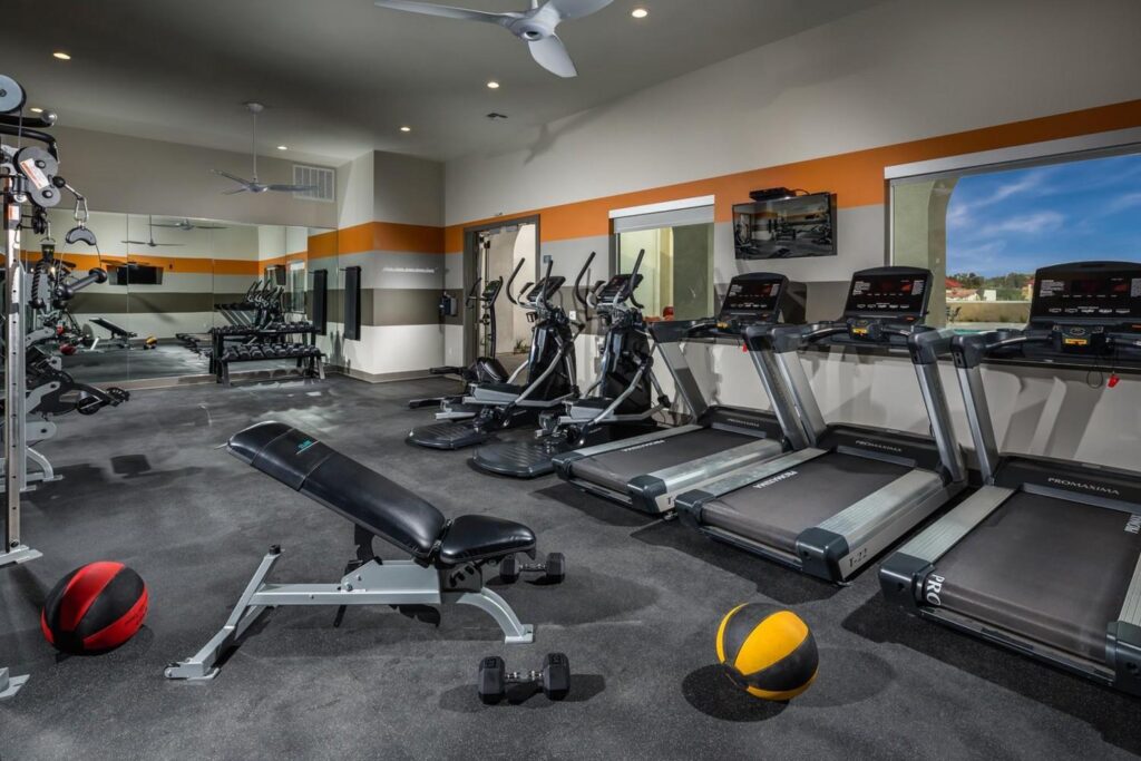fitness center with modern equipment for cardio and some weights