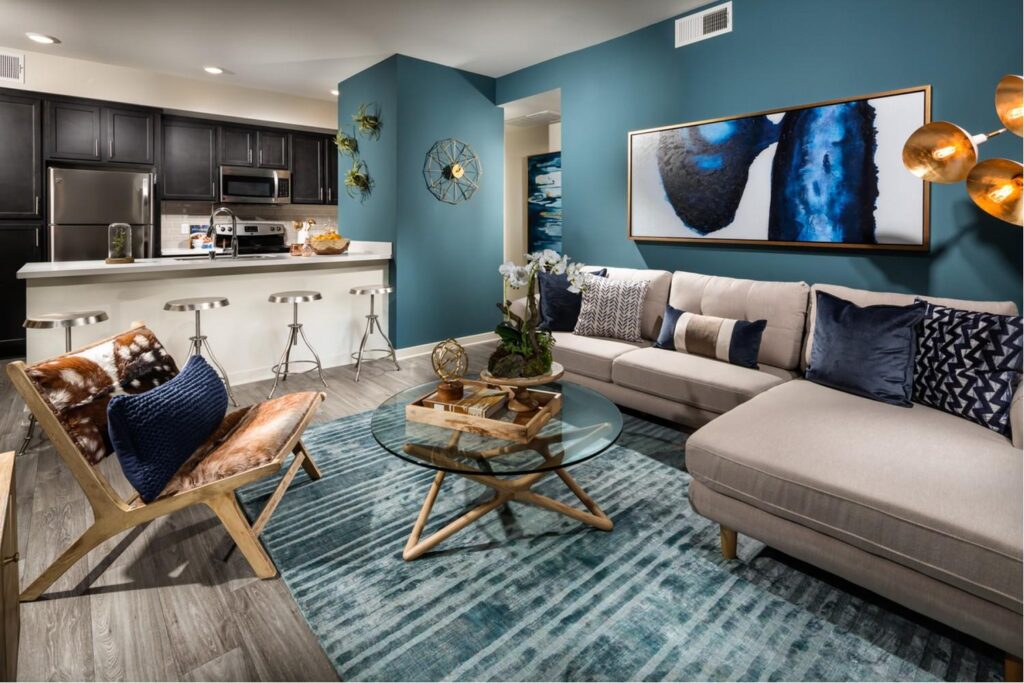 Living room with ultra wide wall art, couch, coffee table and open kitchen