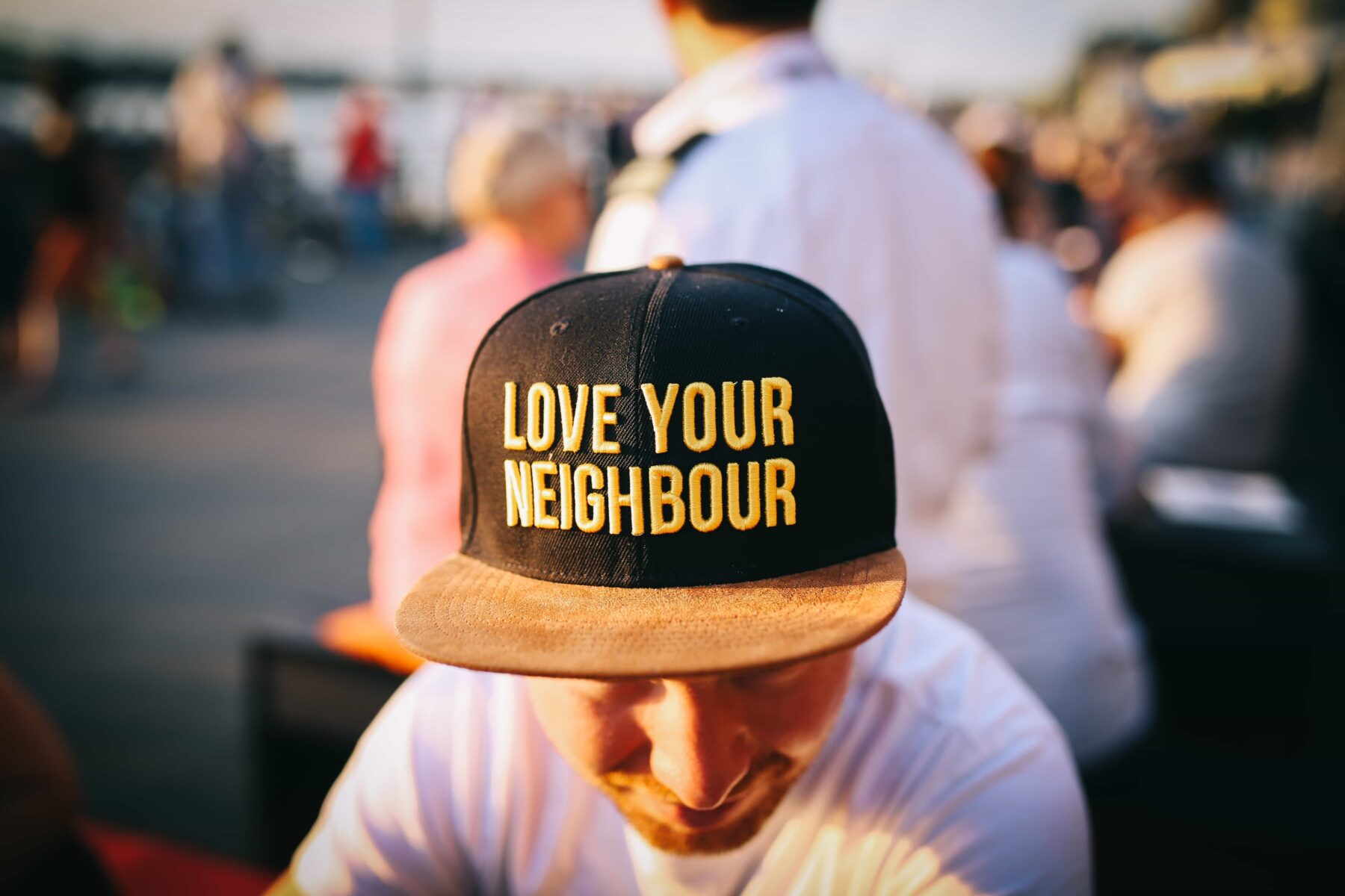a man wearing a baseball cap that says love your neighbor