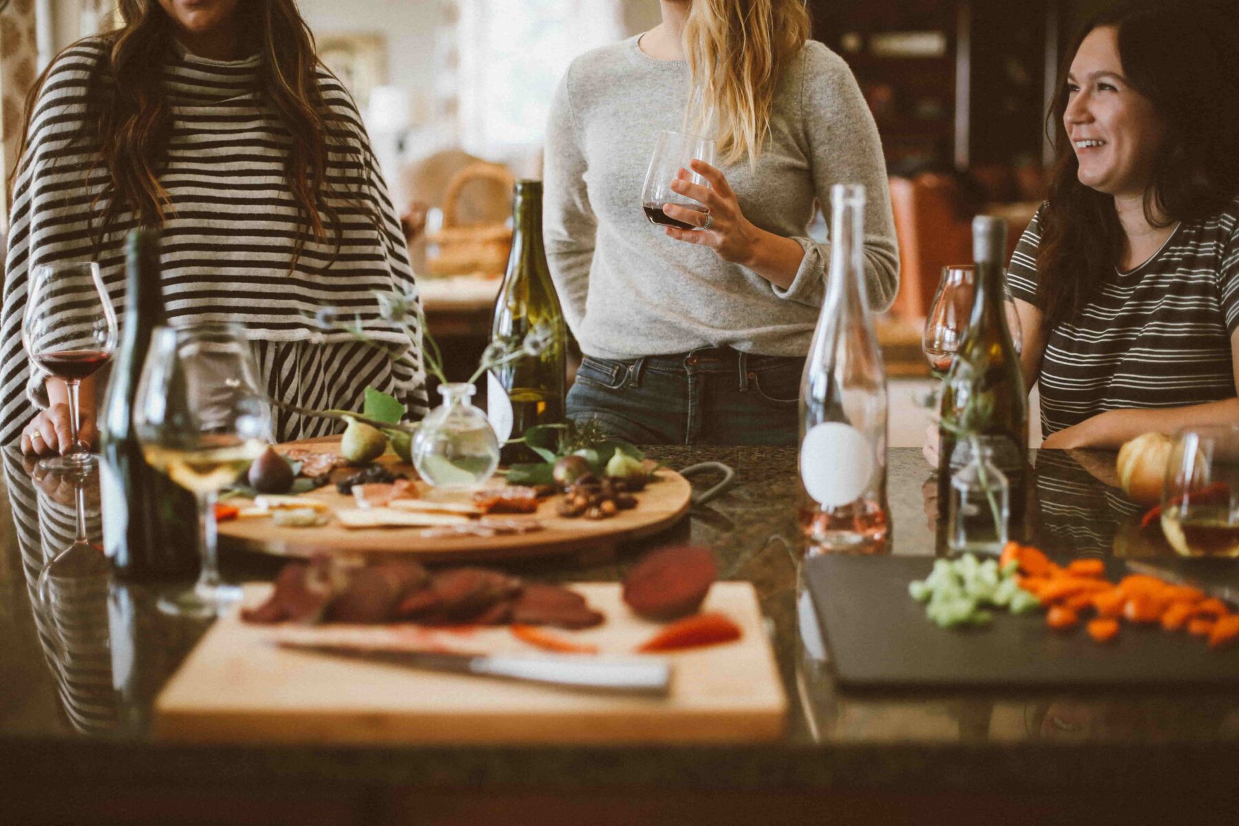 friends gathered around a charcuterie spread