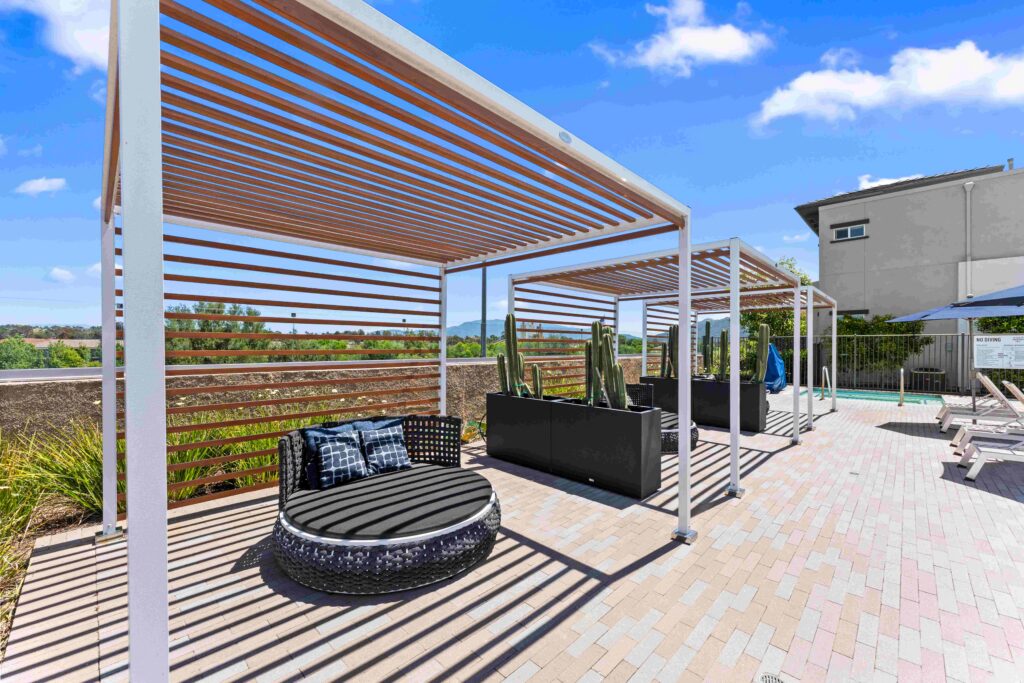Poolside lounge area with shaded cabanas.