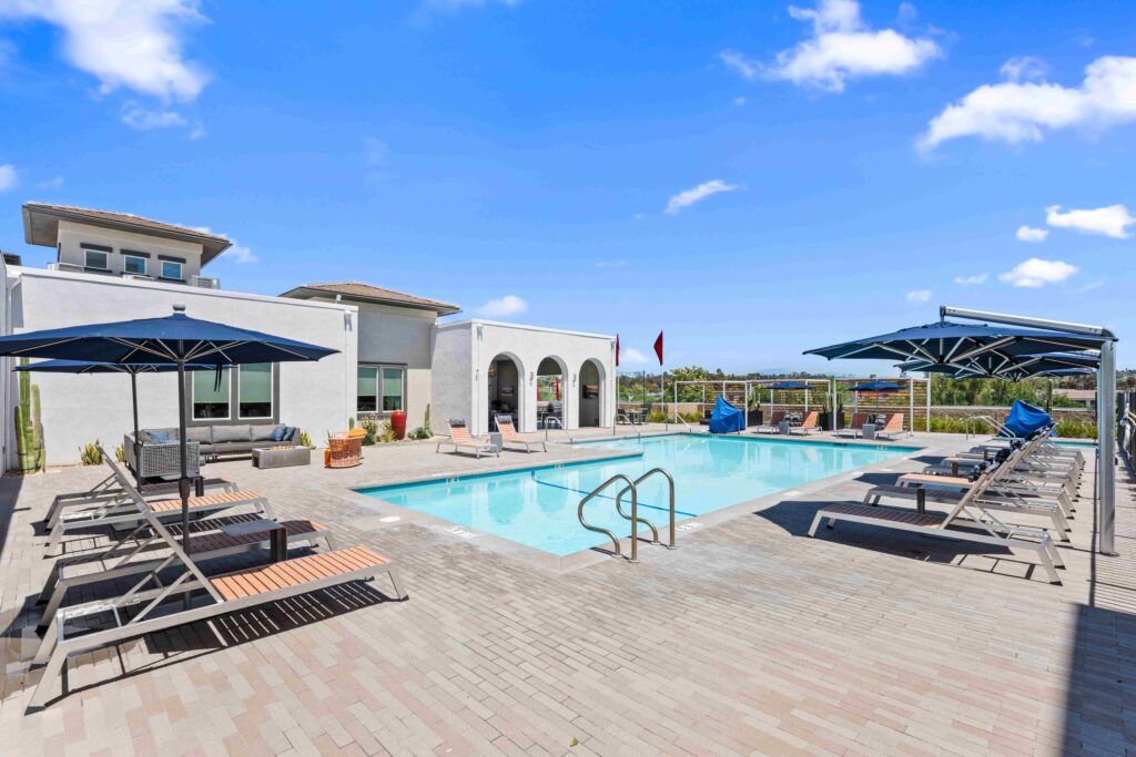 Pool with lounge chairs at Solaire Old Town Temecula apartments.