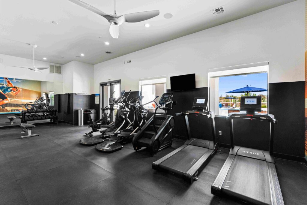 fitness center with modern equipment for cardio and some weights